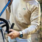 Model wearing the Drive & Ride Sweater by Classycles, showcasing an elegant embroidered car and road bike design, perfect for cycling enthusiasts who value style and adventure.